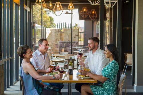 a group of people sitting at a table in a restaurant at Berri Hotel in Berri
