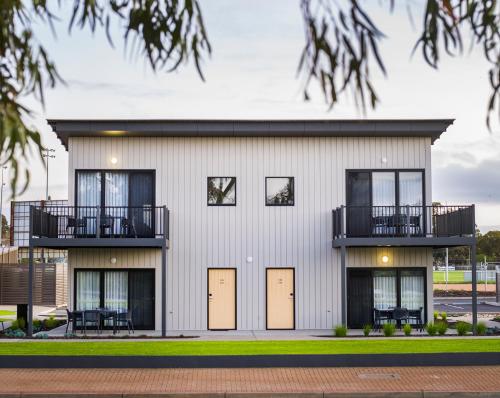 a large white building with doors and a balcony at Berri Hotel in Berri