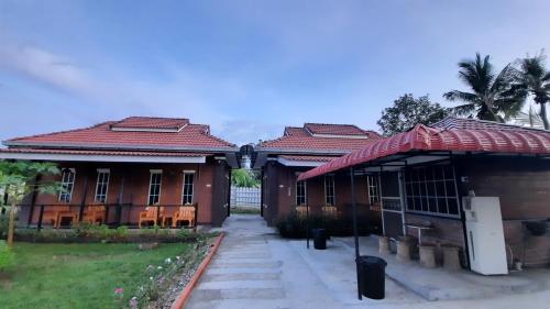 an old house with a red roof at GekQ Inn Langkawi in Pantai Cenang