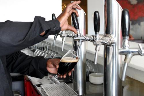 a man is holding a glass of wine at Yaya Hotel & Apartments in Nairobi