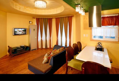 a living room with a table and a dining room at Korea Quality Elf Hotel in Pyeongchang