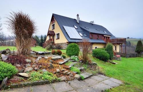 a house with a solar roof with a garden at Family apartments V Zátiší in Dolní Morava