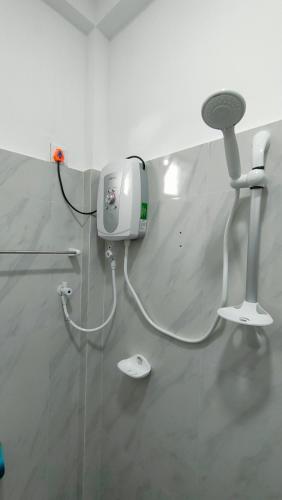 a hair dryer on the wall of a room at Victory's Gardens in Mannar