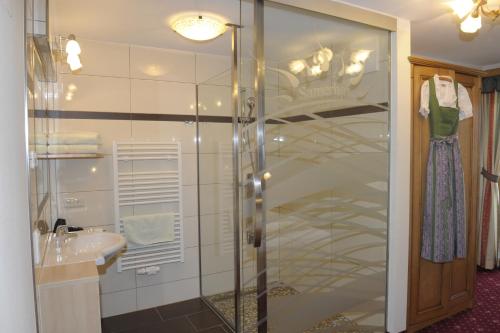 a bathroom with a glass shower and a sink at Bio-Bauernhof Samerhof in Mariapfarr