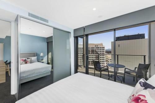 a bedroom with a bed and a balcony at Accommodate Canberra - Highgate in Canberra