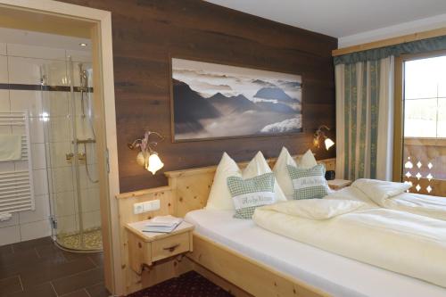 a bedroom with two beds and a shower at Bio-Bauernhof Samerhof in Mariapfarr