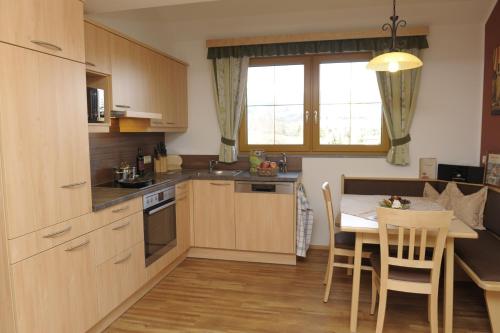 a kitchen with a table and a dining room at Bio-Bauernhof Samerhof in Mariapfarr