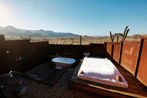 a bathroom with a tub and a toilet in the desert at Sacred Sands in Joshua Tree