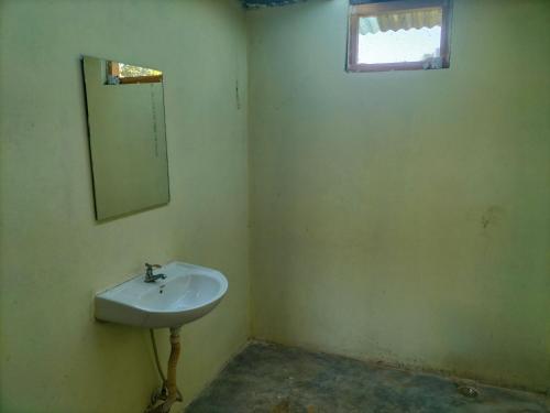 a bathroom with a sink and a mirror at Namaste Bardiya Resort in Bhurkīā