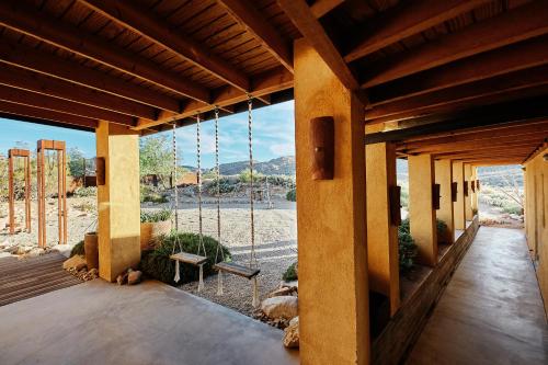 a house with a porch with a view of the desert at Sacred Sands in Joshua Tree