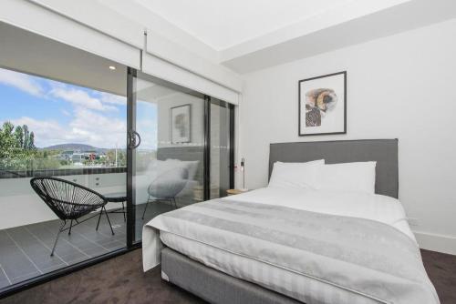 a bedroom with a large bed and a balcony at The Prince 228 Kingston ACT in Canberra