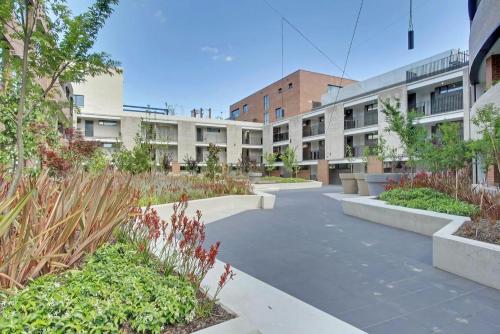 a courtyard of an apartment building with plants at The Prince 228 Kingston ACT in Canberra