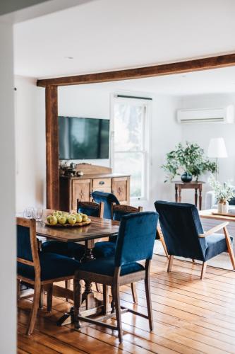 a dining room with a wooden table and chairs at Naivasha Cottage in Deloraine