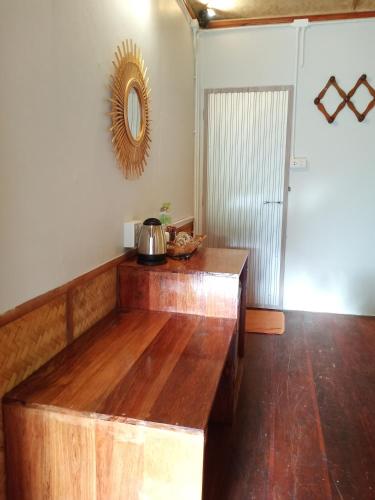 a kitchen with a wooden counter top and a mirror at Mookies Bungalows in Koh Mook