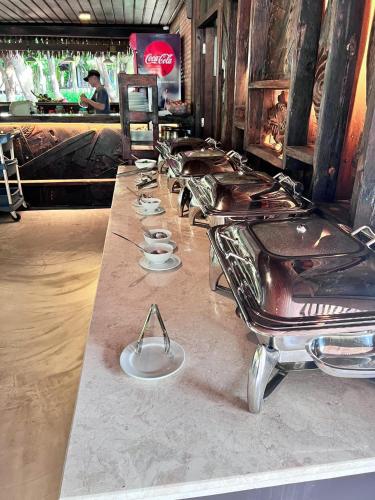 a long counter with a row of tables in a restaurant at Long Hải Channel Beach Resort in Long Hai