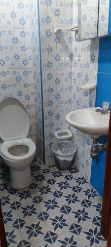 a bathroom with a toilet and a sink at Posada Dakema in Cartagena de Indias