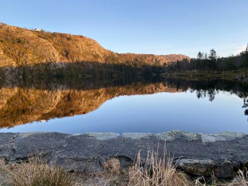 a reflection of a mountain in a lake at Charming Bergen house, rare historic house from 1779, Whole house in Bergen
