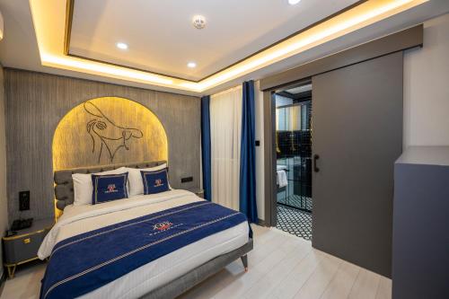 a bedroom with a large bed with a large headboard at Hotel California in Istanbul