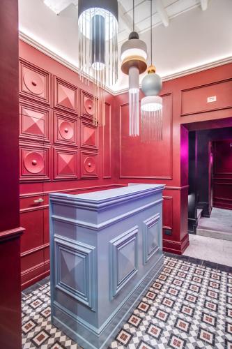 a kitchen with red walls and a blue counter top at Palazzetto Trevi in Rome