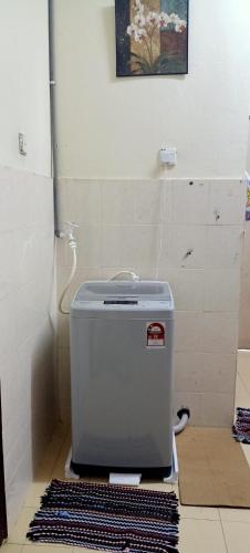 a toaster sitting on the floor in a bathroom at Syah Homestay in Dungun