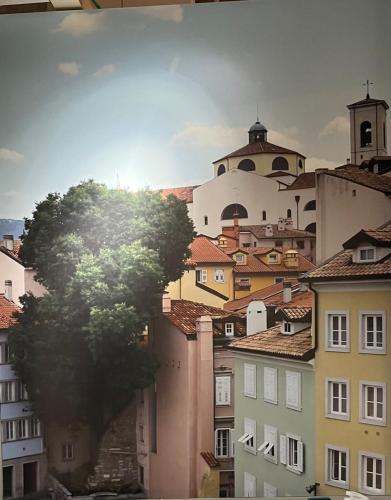 a view of a city with a tree and buildings at Barbacan Boutique Hotel in Trieste