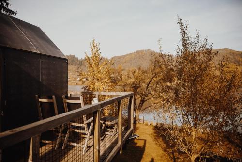 a balcony of a house with a view of a river at Luxury glamping Chocolate village in Maribor