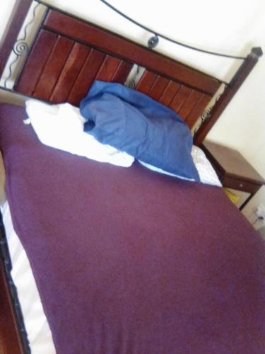 a bunk bed with a blue blanket on it at Sugar Shack Backpackers Botswana in Gaborone
