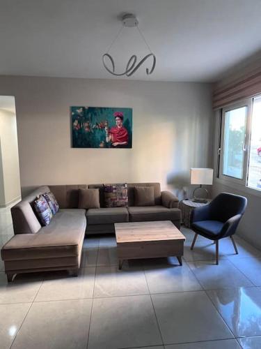 a living room with a couch and a table at Comfy big apartment in Athens in Athens