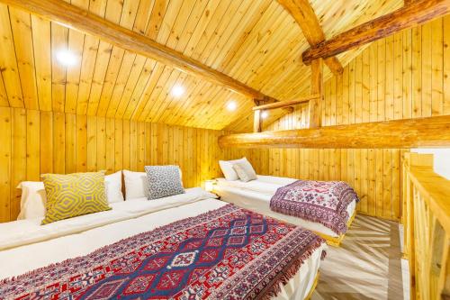 sypialnia z 2 łóżkami w drewnianym domku w obiekcie Mu Ning B&B w mieście Huairou
