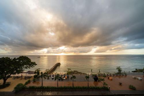 a view of a beach with a cloudy sky and the ocean at The Reef Island Resort Mactan, Cebu in Mactan