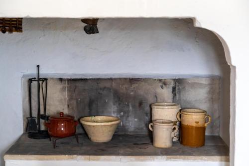 a group of pots and pans sitting on a shelf at MASSERIA SCALEDDA in Manduria