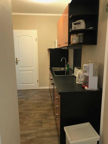 a kitchen with a black counter and a sink at Ferienwohnung Eckloff in Lutherstadt Wittenberg