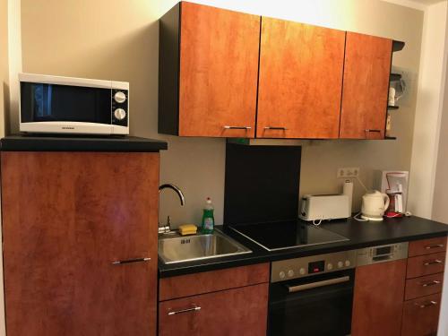 a kitchen with a sink and a microwave at Ferienwohnung Eckloff in Lutherstadt Wittenberg