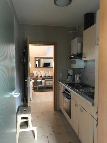 a kitchen with a stove and a stool in it at Ferienwohnung Eckloff in Lutherstadt Wittenberg