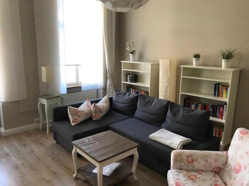 a living room with a blue couch and a table at Ferienwohnung Eckloff in Lutherstadt Wittenberg
