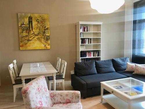 a living room with a blue couch and a table at Ferienwohnung Eckloff in Lutherstadt Wittenberg
