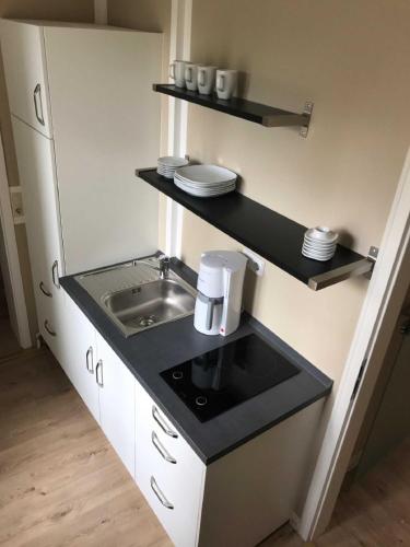 a small kitchen with a sink and a counter at Ferienwohnung Eckloff in Lutherstadt Wittenberg