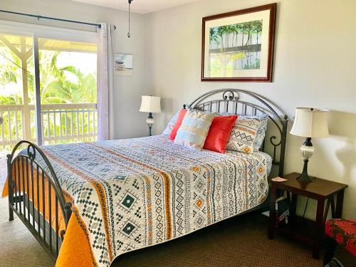 a bedroom with a bed and a window with a balcony at The big house - 30 days in Kailua-Kona