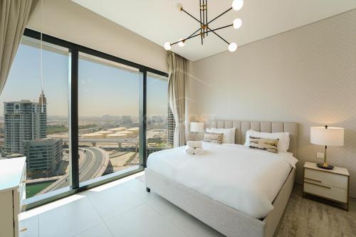 a bedroom with a white bed and a large window at KeyHost - Stunning 1BR - The Address Beach Residences JBR -Dubai Marina View - K1470 in Dubai