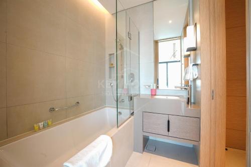 a bathroom with a tub and a sink and a shower at KeyHost - Stunning 1BR - The Address Beach Residences JBR -Dubai Marina View - K1470 in Dubai
