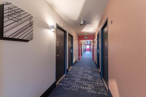 a corridor of a hallway with a long hallway at B&B HOTEL Lieusaint Carré Sénart in Lieusaint