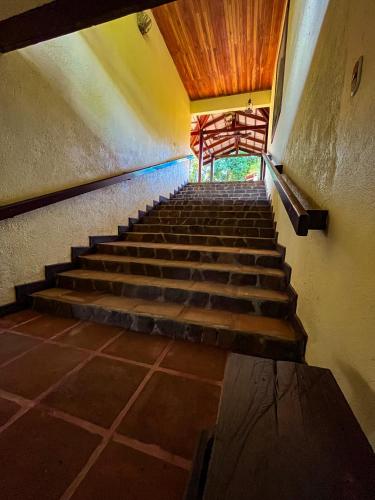 a staircase in an old building with a wooden ceiling at Princesa de la Luna Ecolodge in Fortuna