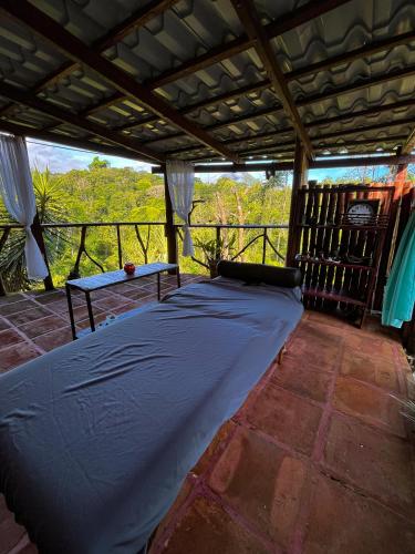 a large bed in a room with a roof at Princesa de la Luna Ecolodge in Fortuna