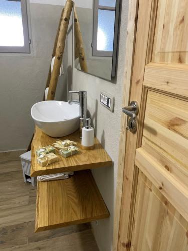 a bathroom with a sink on a wooden table at Locazione turistica Cascina Pela in Castagnole Lanze