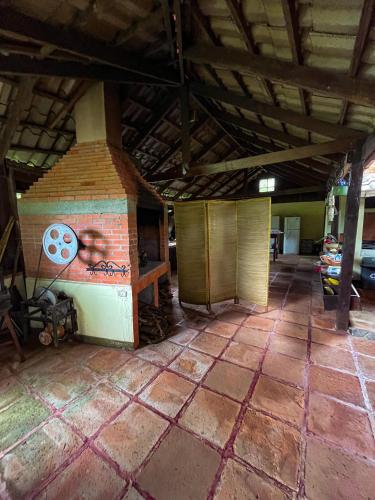 an empty room with a brick fireplace in a building at Princesa de la Luna Ecolodge in Fortuna
