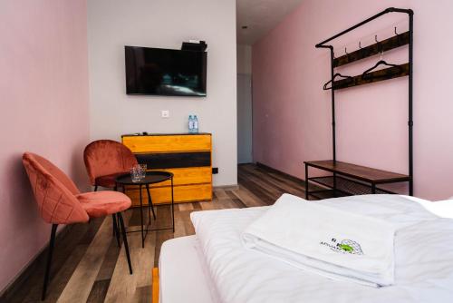 a bedroom with a bed and a tv and a table at Tenis Park Advantage in Bielsko-Biala