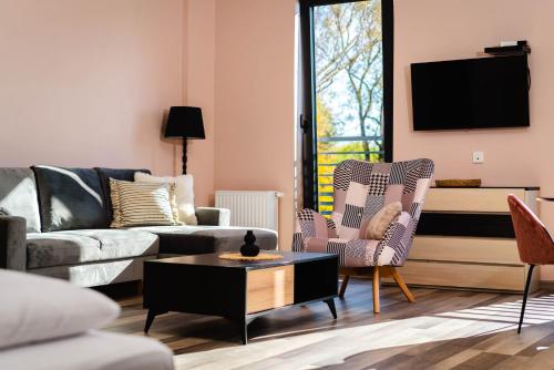 a living room with a couch and chairs and a tv at Tenis Park Advantage in Bielsko-Biala