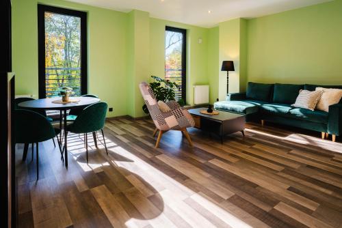 a living room with a couch and a table at Tenis Park Advantage in Bielsko-Biała