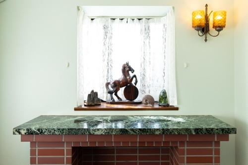 a fireplace with a statue of a horse in a window at 品川ウィステリアレジデンス - Shinagawa Wisteria Residence in Tokyo