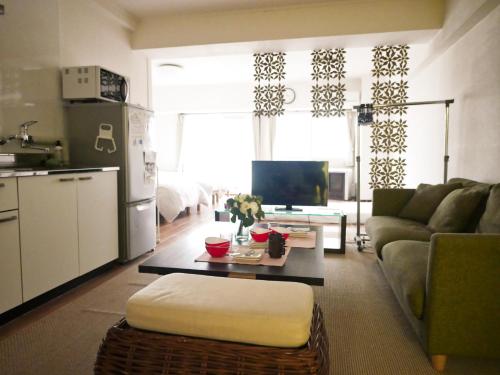 a living room with a couch and a table at SP HOTEL in Sapporo